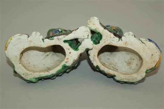 A pair of Chinese famille verte glazed biscuit figure of recumbent lion-dogs, 19th century, 10cm